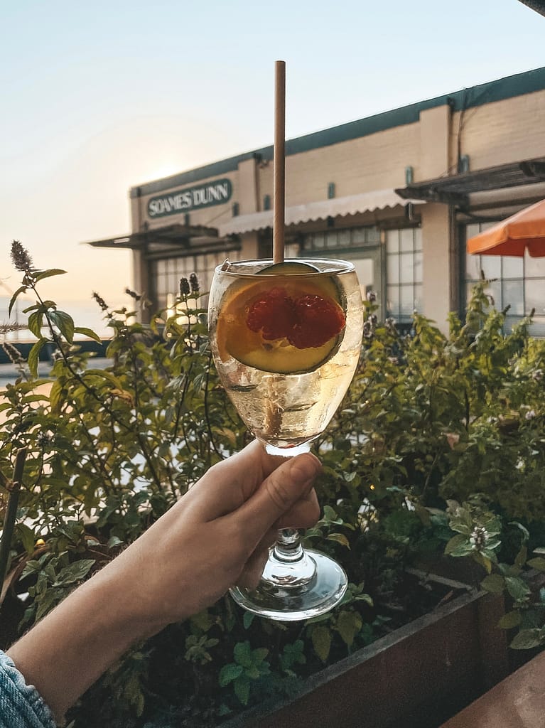 A white sangria in front of the sunset in Seattle at The Pink Door.