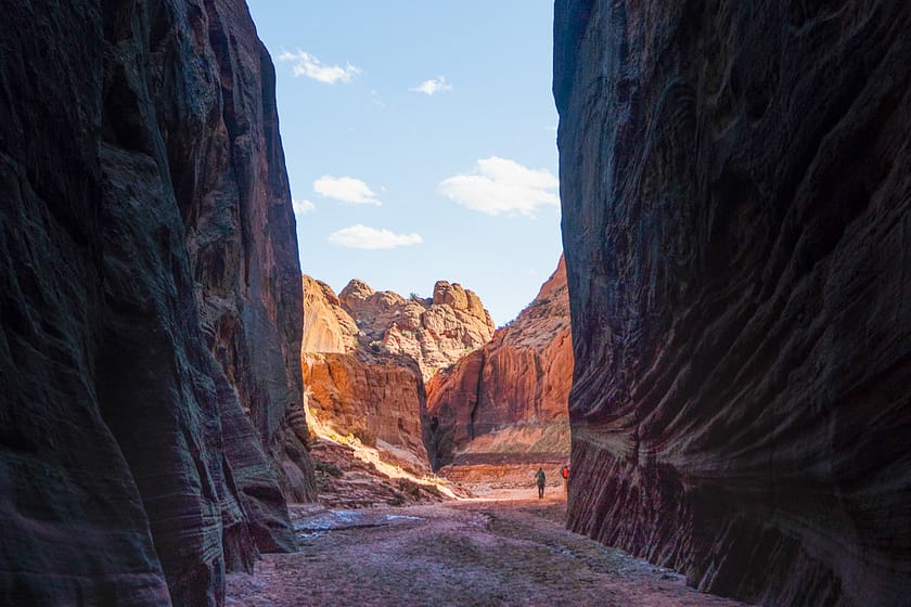 A slot canyon in Utah featuring red rocks and the blue sky