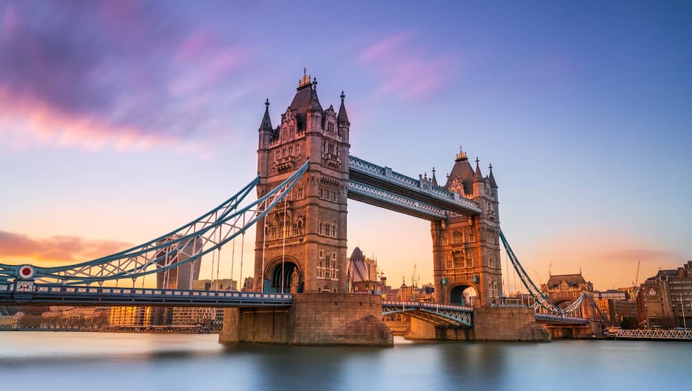 Tower Bridge at sunset over the Thames River.