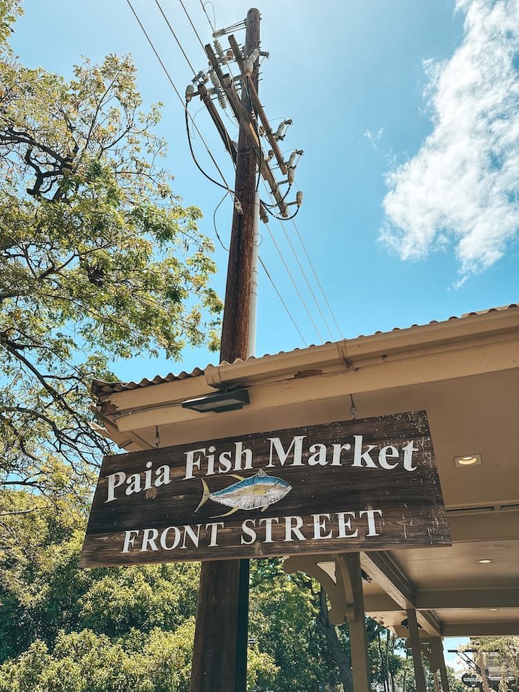 A wooden sign that reads "Paia Fish Market Front Street," with a fish on it: one of the best places to eat in Maui.